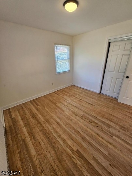 spare room featuring light hardwood / wood-style flooring