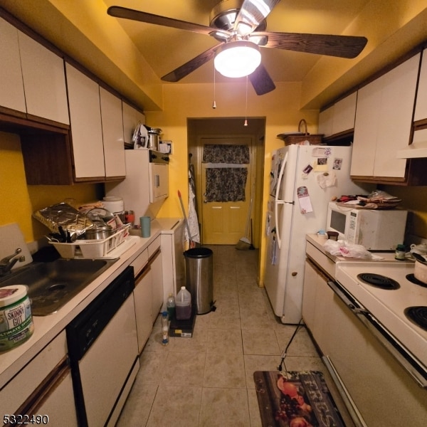 kitchen with white cabinetry, sink, white appliances, and light tile patterned flooring