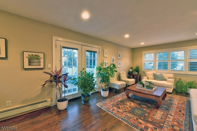 living room with baseboard heating, dark wood-type flooring, french doors, and plenty of natural light