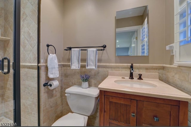 bathroom with vanity, toilet, tile walls, and an enclosed shower