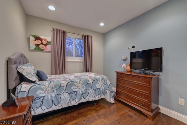 bedroom with dark hardwood / wood-style flooring