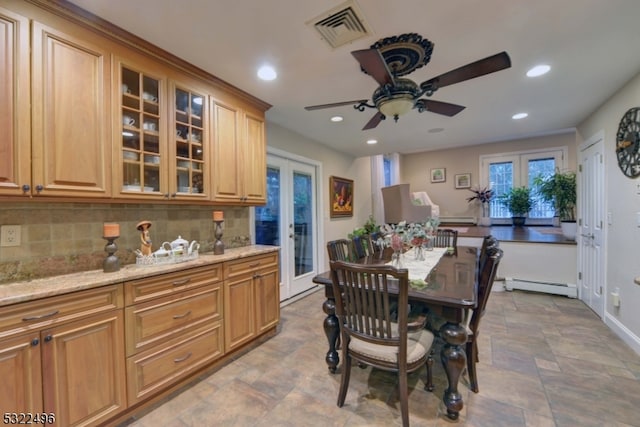 dining space featuring french doors, a baseboard radiator, and ceiling fan