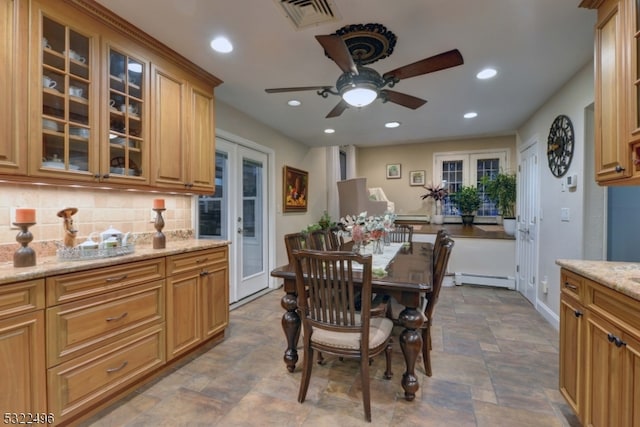 dining space with a baseboard radiator, french doors, and ceiling fan