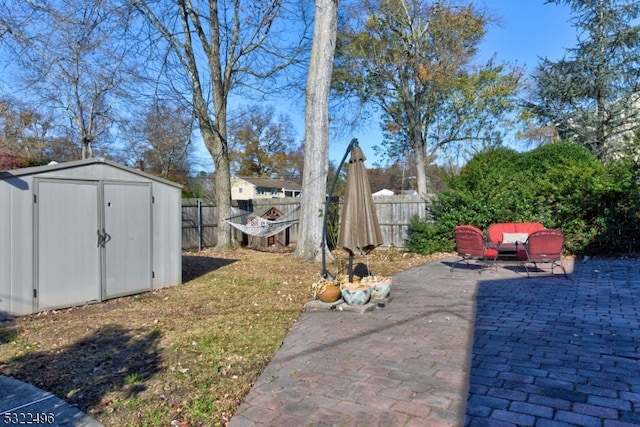 view of yard featuring a patio area and a storage shed