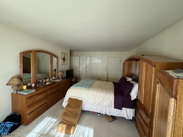 bedroom featuring light carpet