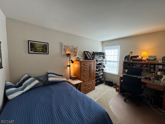 bedroom featuring light colored carpet