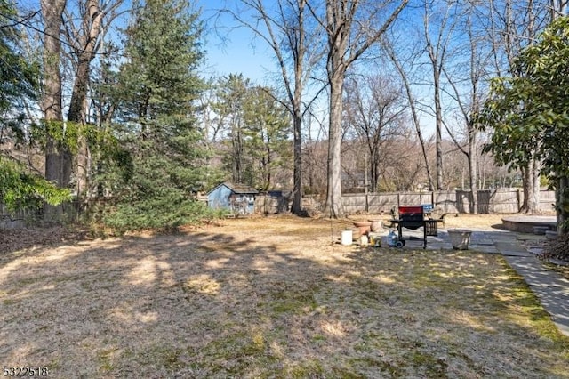 view of yard featuring fence and an outdoor structure