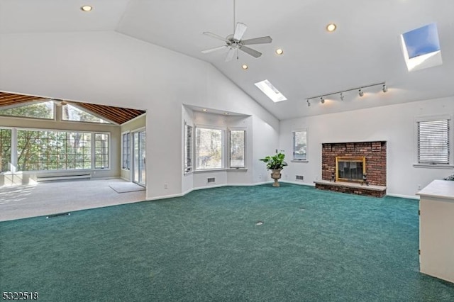 unfurnished living room with carpet, a brick fireplace, plenty of natural light, and a skylight