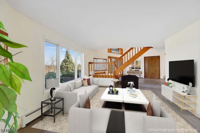 living room with baseboard heating and wood-type flooring