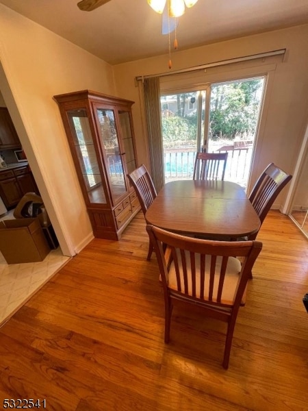 dining area featuring light wood-type flooring and ceiling fan