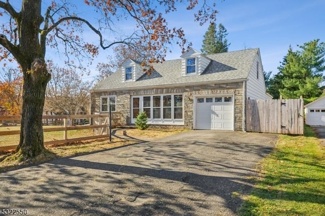 18 Valley View Ave, Peapack Gladstone Boro, NJ 07934 - cape cod home featuring stone siding, asphalt driveway, fence, and an attached garage