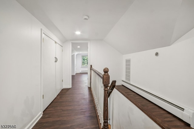 corridor featuring a baseboard radiator, dark hardwood / wood-style floors, and vaulted ceiling