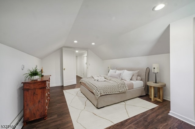 bedroom with vaulted ceiling and dark hardwood / wood-style flooring