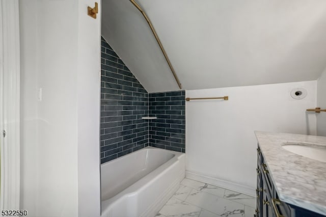 bathroom featuring vanity and lofted ceiling