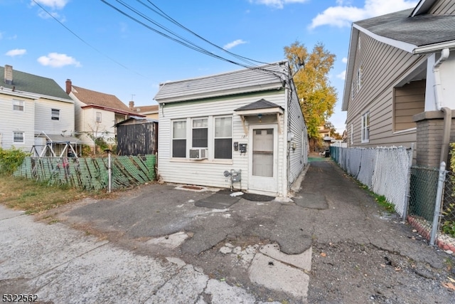 view of front of property with a garage and cooling unit