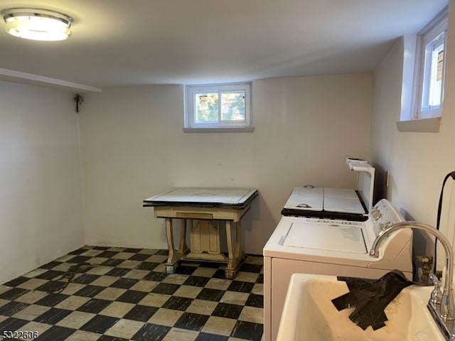 clothes washing area with plenty of natural light and washing machine and clothes dryer