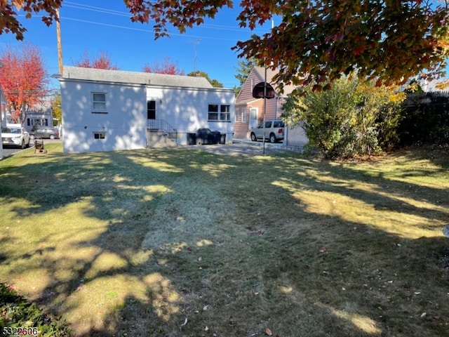 back of house featuring a yard