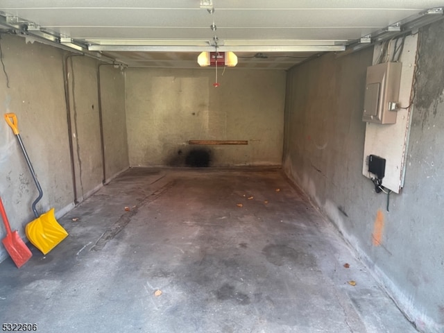 garage with electric panel and a garage door opener