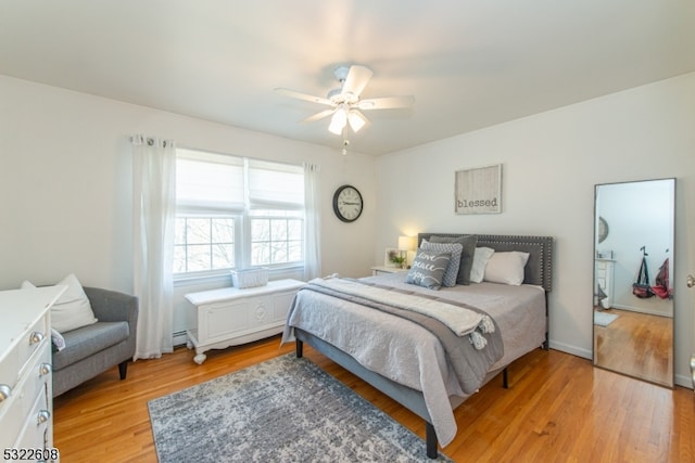 bedroom with ceiling fan and light hardwood / wood-style floors