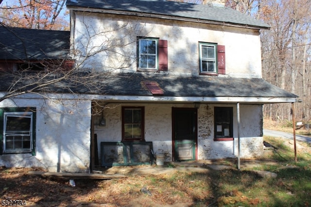 back of property with a porch