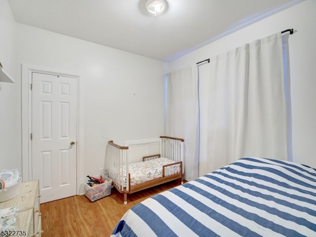 bedroom with wood-type flooring