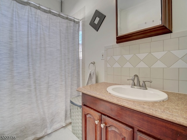 bathroom featuring tile walls, curtained shower, vanity, and tasteful backsplash