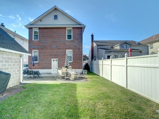 rear view of property with a patio area and a yard