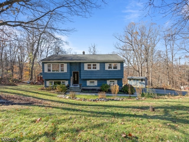 bi-level home with a front lawn