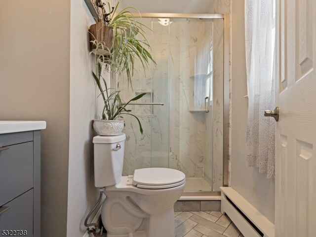 bathroom featuring a shower with door, a baseboard radiator, toilet, and tile patterned floors