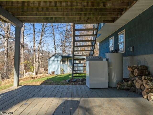 deck with water heater, a pergola, and washer / dryer