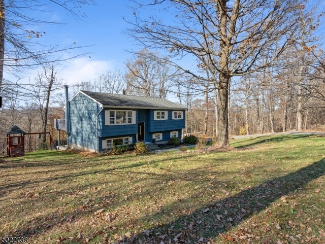 bi-level home with a front lawn