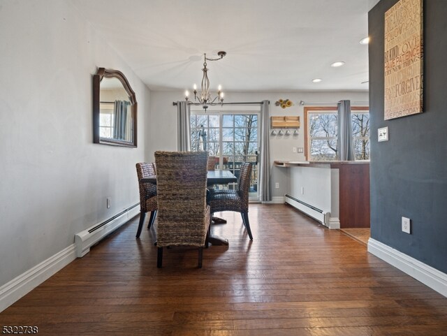 dining room with baseboard heating, dark hardwood / wood-style flooring, and a notable chandelier