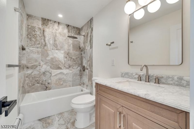 full bathroom with vanity, toilet, baseboard heating, and tiled shower / bath combo