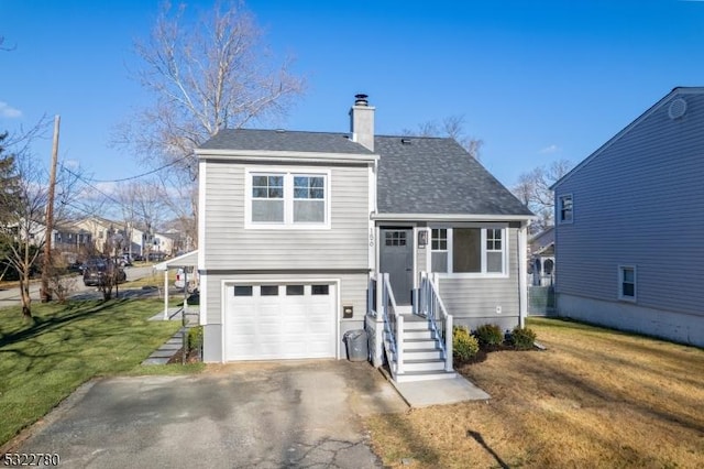 view of front of property featuring a garage and a front lawn