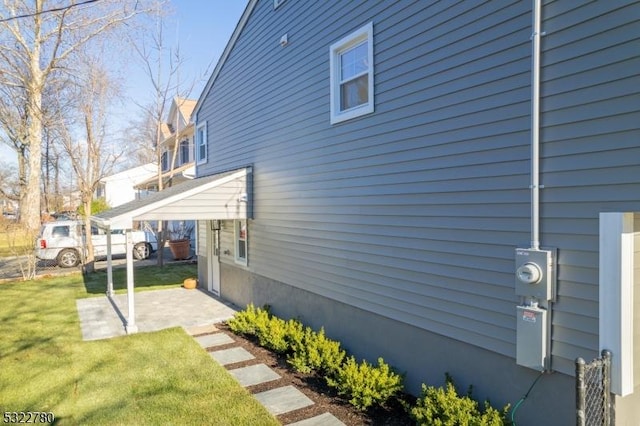 view of side of property with a lawn