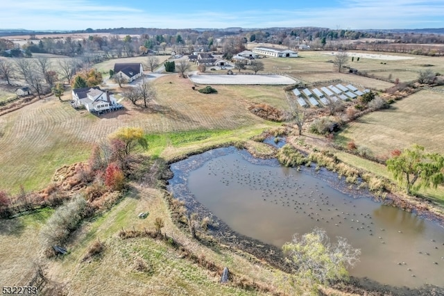 birds eye view of property featuring a rural view and a water view