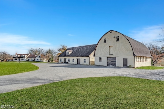 view of outbuilding featuring a lawn