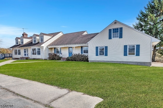 cape cod house with a front lawn