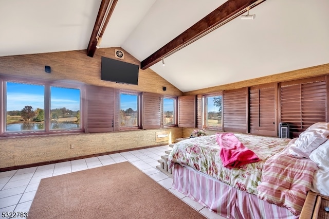 bedroom with multiple windows, light tile patterned flooring, high vaulted ceiling, and beam ceiling