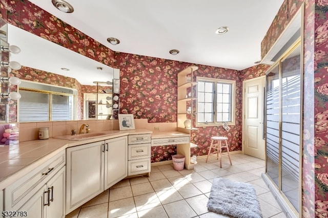 bathroom with tile patterned flooring, vanity, and a shower with shower door