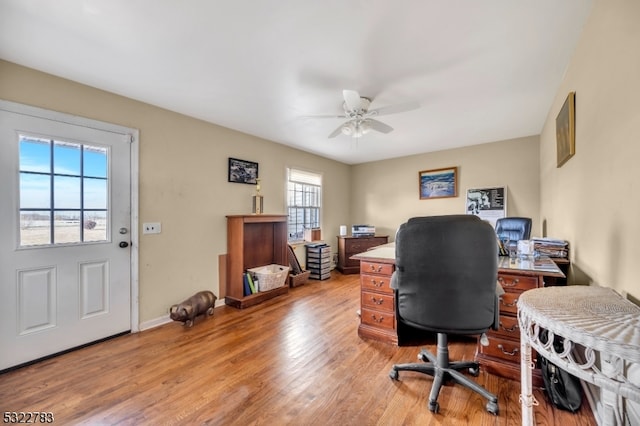 office with light hardwood / wood-style flooring and ceiling fan