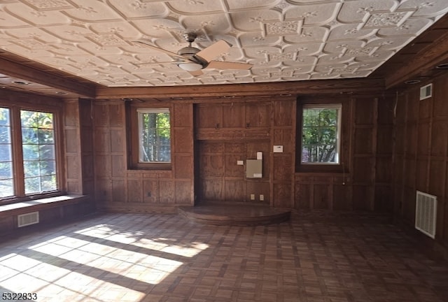 foyer entrance with wood walls and plenty of natural light