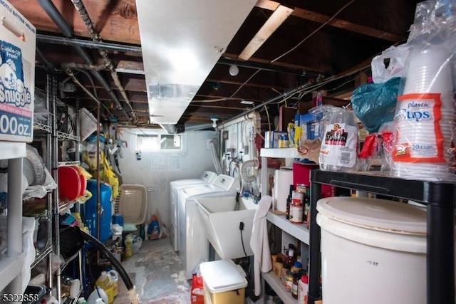 interior space with a sink and washer and clothes dryer