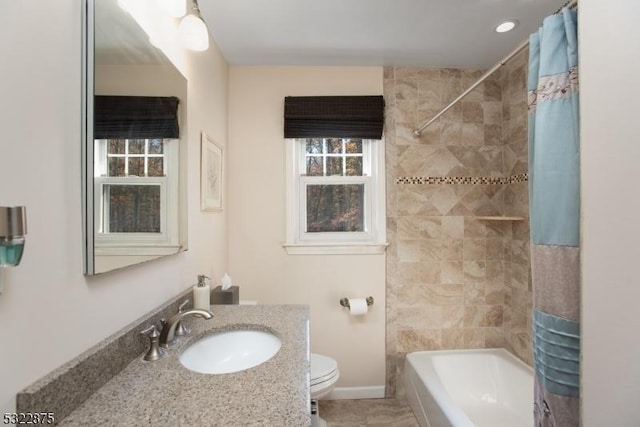 bathroom with toilet, baseboards, shower / bath combo with shower curtain, and vanity