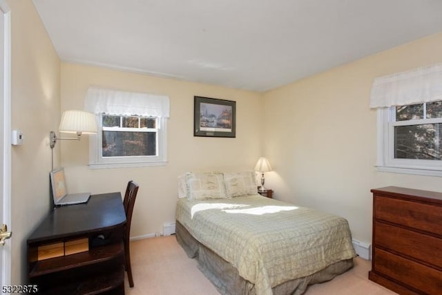 carpeted bedroom featuring a baseboard heating unit