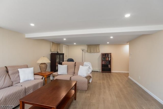 living area with baseboards, light wood-type flooring, and recessed lighting