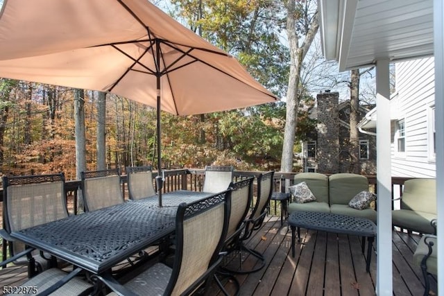 wooden terrace featuring outdoor dining space