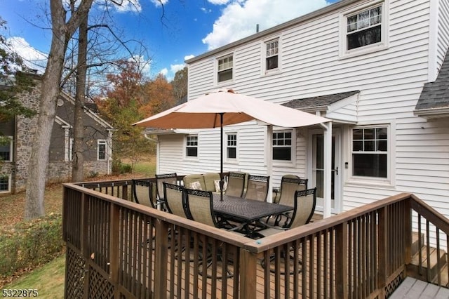 wooden terrace featuring outdoor dining area