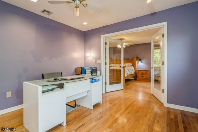 home office featuring ceiling fan, french doors, and light hardwood / wood-style floors