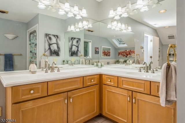 bathroom featuring lofted ceiling, vanity, and tile patterned floors